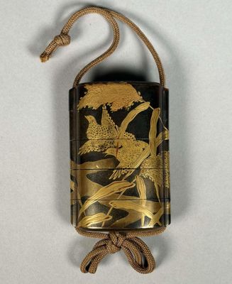 an old cell phone case with a bird design hanging from it ' s cord