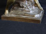 bronze statue of a woman and a dog on a black background