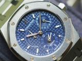 a close up of a watch with a blue dial