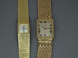 two watches that are sitting next to each other on a table