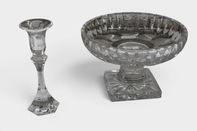 a glass bowl and a glass candle holder on a table