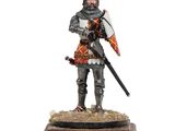 une figurine représentant un homme en armure tenant une épée