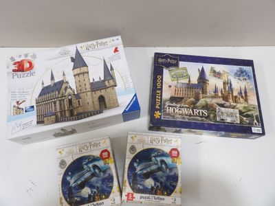 three boxes of puzzles sitting on a table