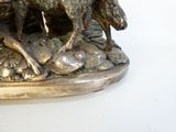 a bronze statue of a horse and a dog on a rock