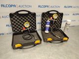 two air compressors in a case with a hose and a pressure gauge