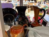 many plates and bowls on the counter in the store