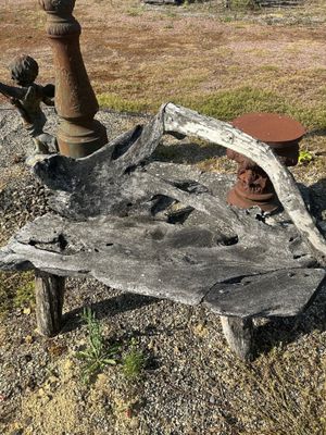 a bench made out of a piece of wood and a fire hydrant