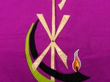 a purple shirt with a cross and a flame on it