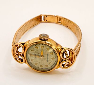 an image of a gold wrist watch with a chain around it