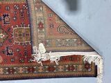a rug on the floor with a piece of fabric on it