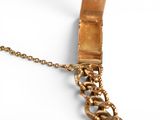 gold plated necklace with a chain and clasp on a white surface
