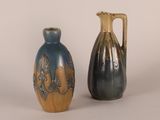 two vases sitting next to each other on a white surface