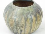 a vase that is sitting on a white surface