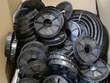 a cardboard box filled with many different types of spools