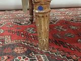 a cat that is sitting on a chair on a rug