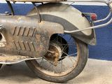 a motorcycle with a basket on the back of it ' s seat