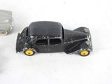 two toy cars sitting next to each other on a white surface