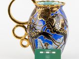 a blue and gold vase with a gold handle on it