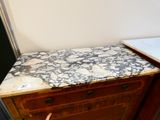 a marble top on a wooden cabinet in a kitchen