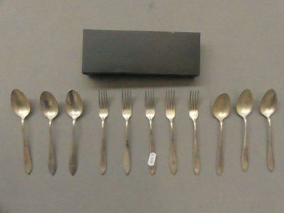 a lot of forks and spoons that are on the table