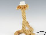a rope that is connected to a lamp on a table