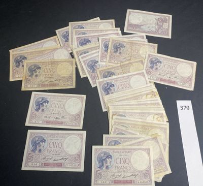 several bills of different currency laid out on top of a table