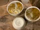 three cups of liquid sitting on a table next to each other