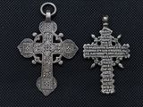 two silver crosses on a black background with a black background