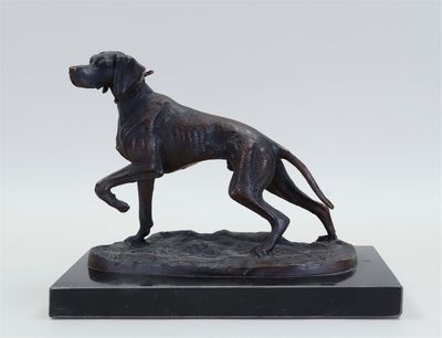 a bronze statue of a dog on a marble base
