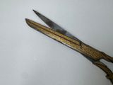 a pair of scissors sitting on a white surface