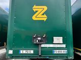 a green truck with a yellow z on the back