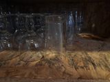 many empty wine glasses lined up on a table
