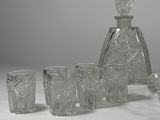 a lot of glasses and a decanter sitting on a table