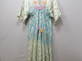 the dress is hanging on a hanger on a wall
