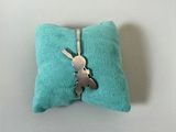 a small pillow with a bunny on it on a table