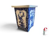 a blue and white vase with a picture of a bird on it