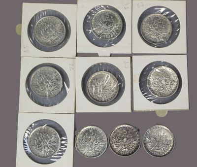 six different types of silver coins are shown in a display case