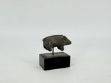 statue of a pig on a wooden base on a white background