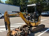 a small bulldozer that is parked in a parking lot
