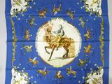 an image of a blue scarf with a picture of a man on a horse