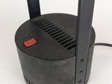 a close up of a black light with a red button on it