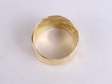 a close up of a gold ring on a white surface