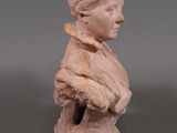 marble bust of a woman with a hat on her head