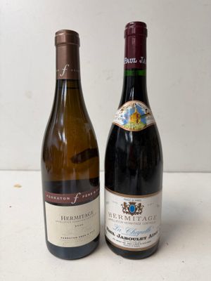 two bottles of wine sitting next to each other on a table