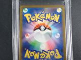 a close up of a pokemon card in a plastic case