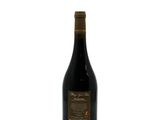 a bottle of wine sitting on top of a white surface