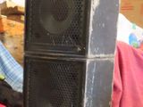two speakers sitting on top of a table in a room