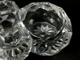 a close up of a glass candle holder on a table