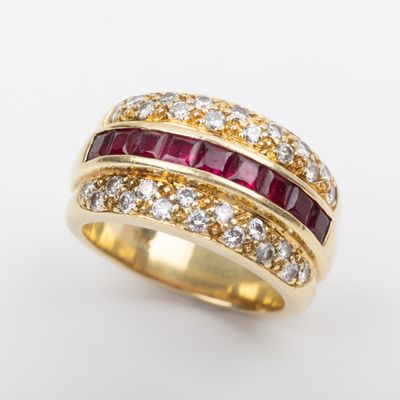 a close up of a gold ring with rubies and diamonds