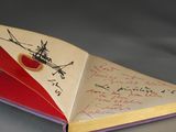 an open book with writing on it sitting on a table